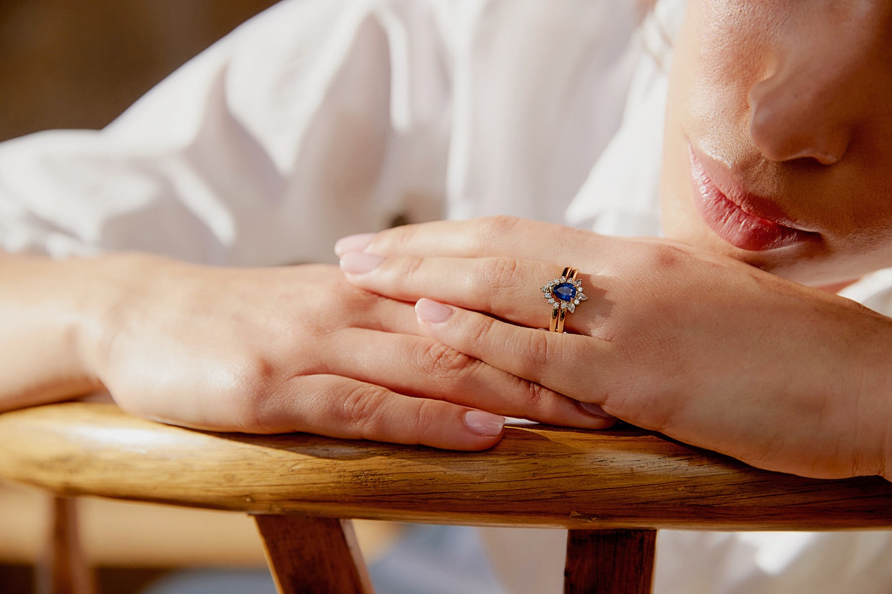 Blue sapphire engagement ring worn in warm natural light